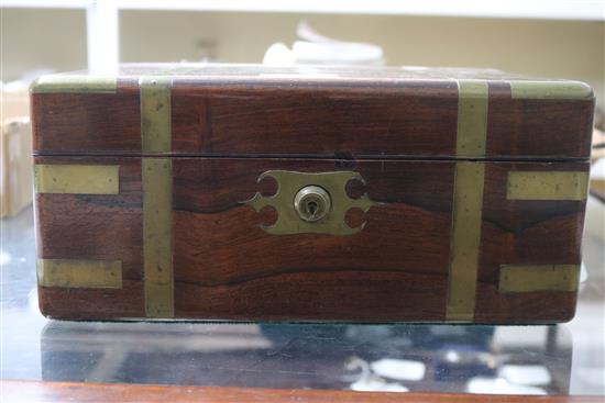 A Victorian brass mounted rosewood toilet box, containing four silver mounted bottles and four nail implements, box 28cm.